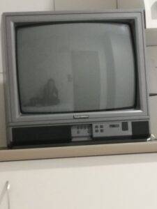 Reflection of a doctor in an old tv set